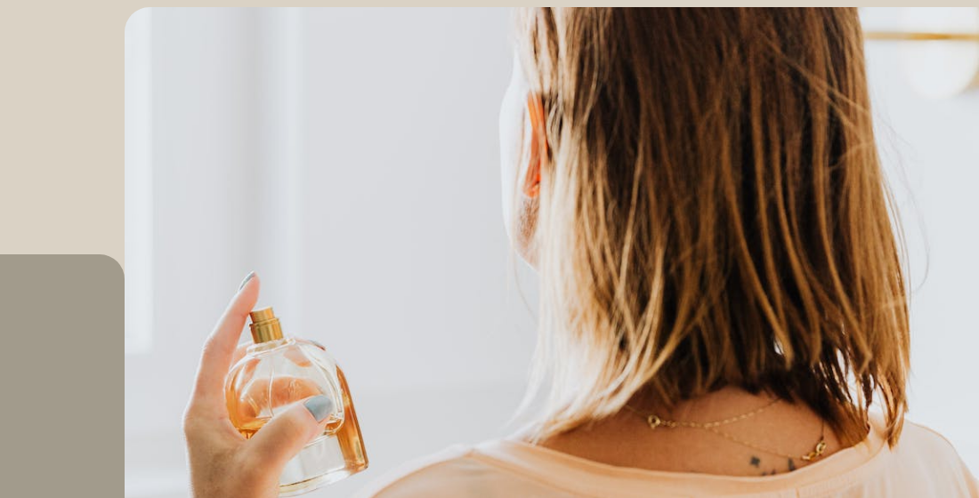 Woman applying fragrance